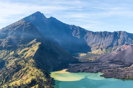 landscape of active volcano Baru Jari, Lake Segara Anak and summit of Rinjani mountain. Lombok island, Indonesia.の写真素材