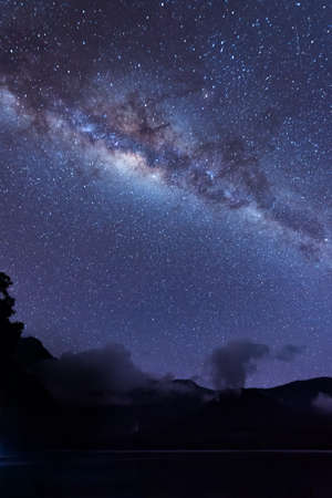 Milky Way landscape. Clearly Milky way above Lake Segara Anak inside crater of Rinjani mountain on night sky. Lombok island, Indonesia.の写真素材