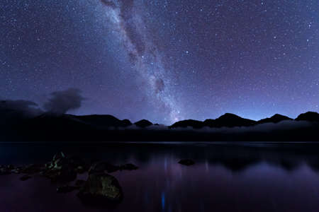 Milky Way landscape. Clearly Milky way above Lake Segara Anak inside crater of Rinjani mountain on night sky. Lombok island, Indonesia.の写真素材
