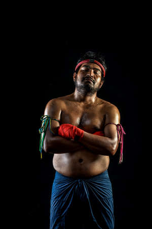 Muai thai boxer man trainings. studio shot on black backgroundの写真素材