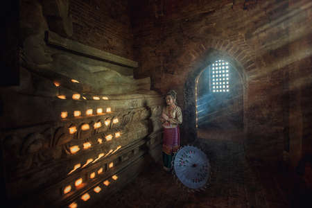 Beautiful girl in Myanmar traditional costume,  identity culture of Myanmar, in Pagdodas of Bagan Myanmar(public place), Happy asian womanの写真素材