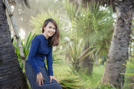 Thai Farmer woman wearing typical Thai dress, on Rice fields background, identity culture of Thailandの写真素材