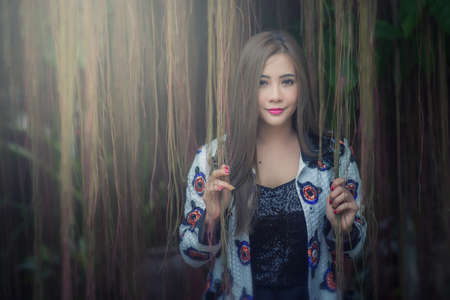 portrait of a beautiful fashion girl wear traditional in treeの写真素材