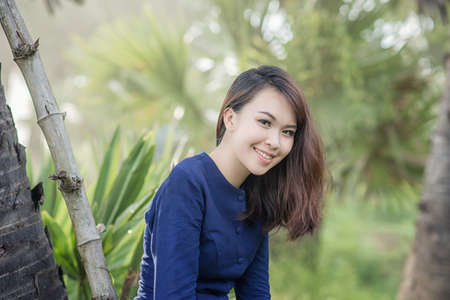 Thai Farmer woman wearing typical Thai dress, on Rice fields background, identity culture of Thailandの写真素材