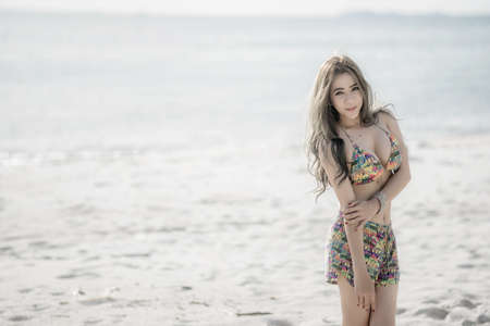 Outdoor fashion portrait of pretty sexy sensual woman in bikini posing outdoor in summer on tropic island on the beach near blue sea and sky and having fun on vacation,Thailandの写真素材