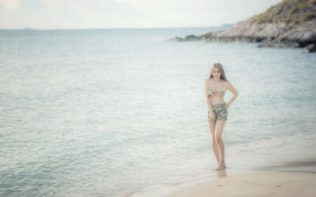 Outdoor fashion portrait of pretty sexy sensual woman in bikini posing outdoor in summer on tropic island on the beach near blue sea and sky and having fun on vacation,Thailandの写真素材