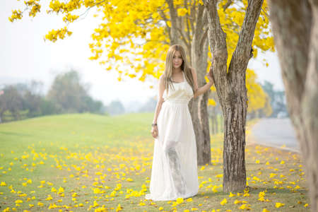 portrait of a beautiful young sexy girl brunette bride with flowers in her hair look attractive in a...