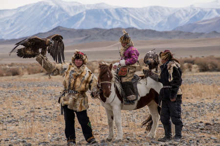 Kazakh Eagle Hunters in traditionally wearing typical Mongolian dress culture of Mongoliashe Rider...