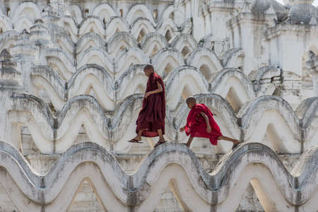 MYANMAR The novice monk walking on the white pagoda in Mandalay Myanmarのeditorial素材