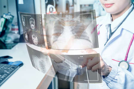 Doctor in futuristic medical concept pressing button operating futuristic medical interface with...