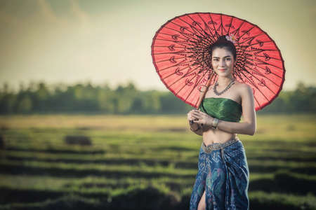Beautiful woman in traditional dress costume, Asian woman wearing typical Thai dress identity culture of Thailandの写真素材