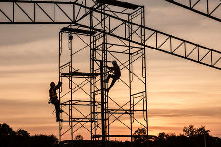 Silhouette Engineers Worker discussion with architects work planing in construction site working on high ground heavy industry and safety conceptの写真素材