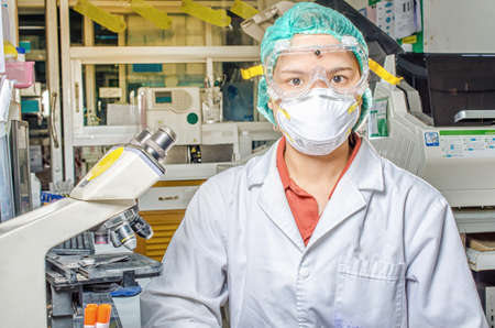Coronavirus covid 19 epidemic disease with doctor or lab technician scientist holding blood sample...