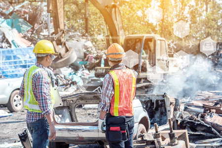 Professional Industrial Mechanical Engineer with Factory Worker while Using Laptop Computer at Metal lathe industrial manufacturing factory. Engineer Operating are working on projects in  factoryの写真素材