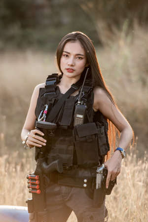 Portrait of beautiful sexy woman with weapons