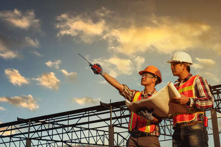 Engineers discussion with architects work planing in construction siteの写真素材