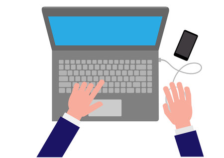 A business man with his hands on the laptop with a smart phone next to it vectorのイラスト素材