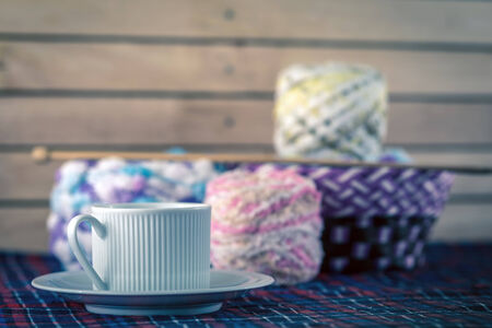 Cup of coffee and Knitting yarn balls and needles.の写真素材