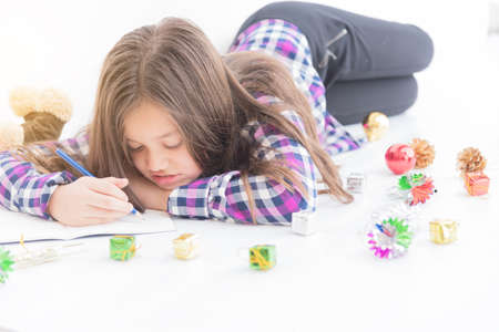 Pretty girl isf writing on note book with blue pencil,copy space..の写真素材