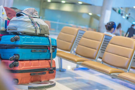 Close up image of many luggages stacking at the airport with passenger seat background,traveling concept,copy space.の写真素材