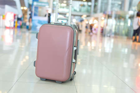 Single luggage on floor at the airport with beautiful bokeh background,travling concept.の写真素材