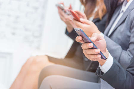 Group of business woman sitting in office and using smartphone, lifestyle and friendship concept,selective focus,copy space.の写真素材