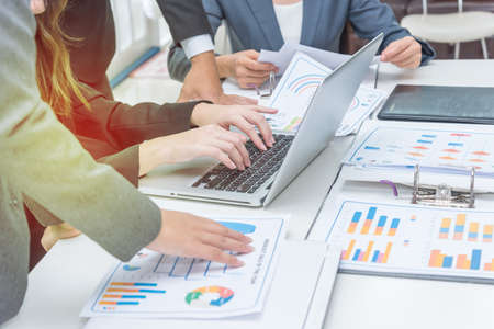 Business woman with beautiful fingers typing on lap top keyboard among friends, team work concept,copy space.の写真素材