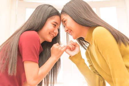 Close up image of two young lady are hand in hand,friendship concept.の写真素材