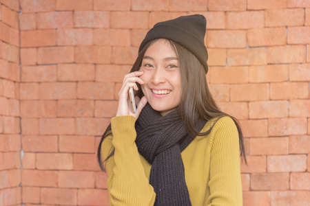 Beautiful Asian woman talking on the smart phone ,technology concept,copyspace.の写真素材