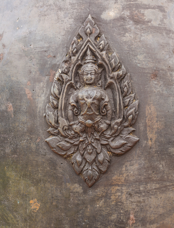 Buddha sculpture image on old bronze surface. Thai style metal carvingの写真素材
