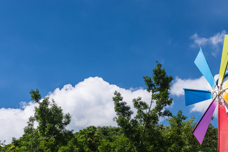 colorful windmill on green park under blue skyの写真素材