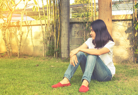 Portrait of a beautiful young asian girl relaxing in parkの写真素材
