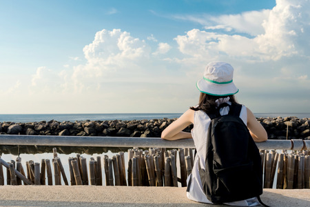 traveler girl looking at the sea side with blue sky, travel and active lifestyle conceptの写真素材
