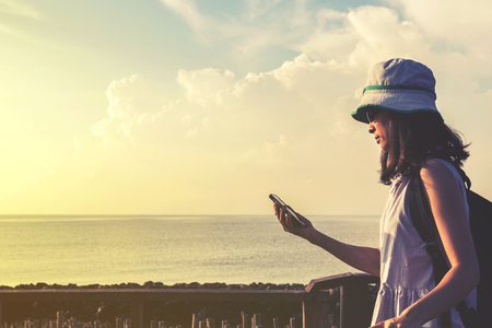 traveler girl looking at the sea side with blue sky, travel and active lifestyle conceptの写真素材