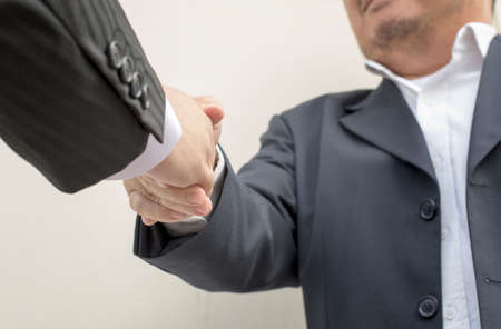 Businessmen shaking hands making an agreementの写真素材