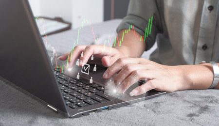 close up businesswoman hand type on laptop for work (from home) of company profit with colleagues partner explain with virtual dashboard statistic chart stock infographic , businesの写真素材