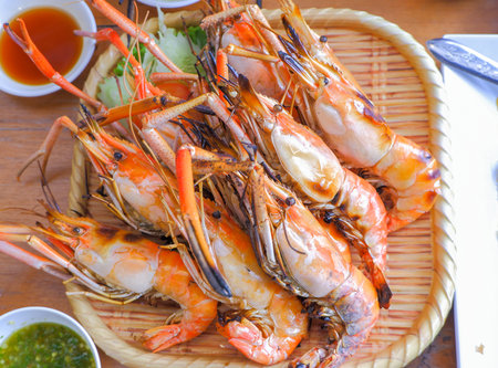 Grilled Big River Prawn Placed on a bamboo plate adorned with cucumbers and lettuce.の写真素材