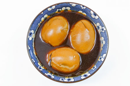 Thai Local Food Egg and Pork in Sweet Brown Sauce on White Backgroundの写真素材