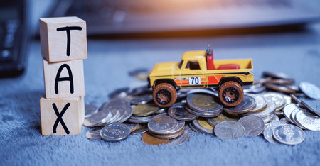 The Concept of taxes for car on block cubes paid by individuals and corporations such as VAT, income tax and property tax Data analysis, paperwork,Financial research.の写真素材