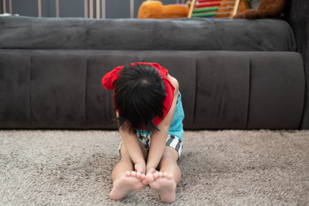 Asian boy in tank top doing exercise And there was a sweat towel on his head.の写真素材