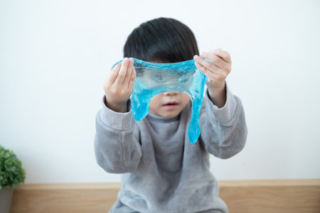 Asian boy having fun playing slam on the floor Learning outside the classroomの写真素材
