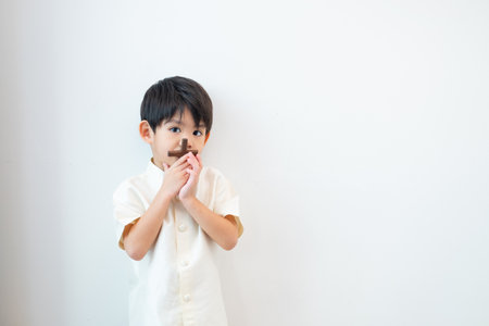 Little Asian boy praying with holding the cross, Christian conceptの写真素材
