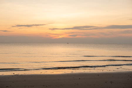 Landscape during sunset at the border of the sea There is a ship floating in the middle of the sea.の写真素材