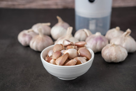 Big and small heads of garlic on a black background.の写真素材