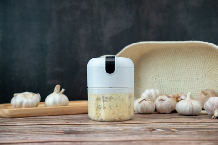 Garlic in a fine blender on a black backgroundの写真素材