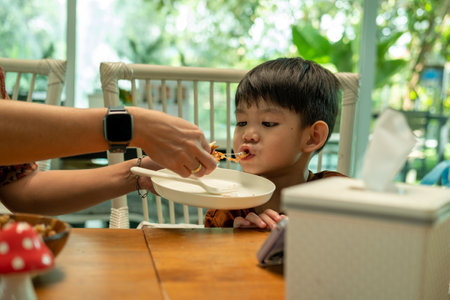 Asian boy eating processed food made from mushroomsの写真素材