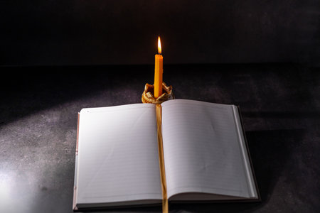 Yellow candlestick gives light while reading, black background