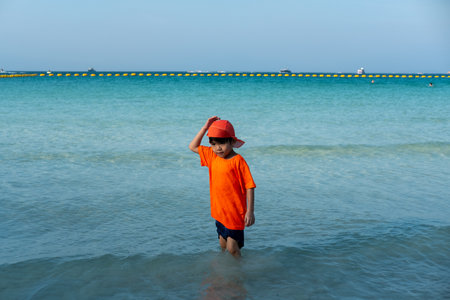 Little Asian boy playing in the sea at the sea beachの写真素材