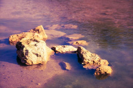 Stones in a water. Soft sunset blue and pink colors.の写真素材
