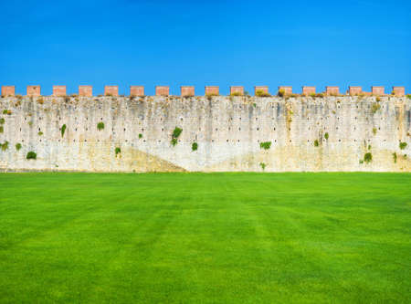 Ancient wall blue sky and green grass.の写真素材